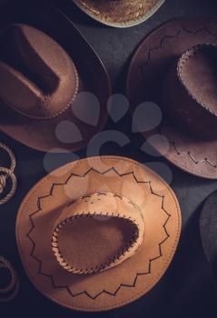 cowboy hat at table wooden background, top view