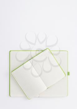notebook at white paper background, top view