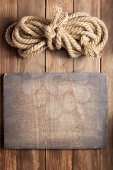 sign board and ship rope at wooden background texture, top veiw