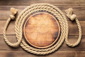 sign board and ship rope at wooden background texture, top veiw
