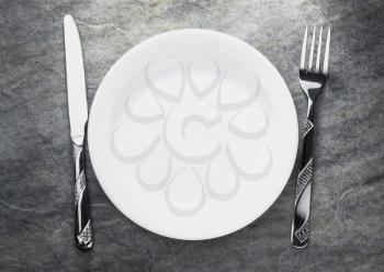 plate, knife and fork on table background