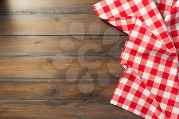 checked napkin cloth on wooden background