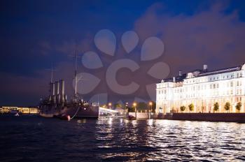 Night photo of the cruiser Aurora, view from the motor ship. Night shooting in the city of St. Petersburg.