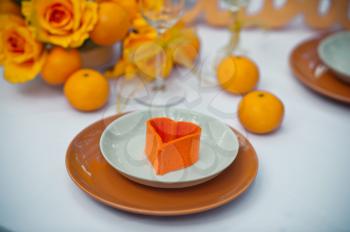 Table with plates and oranges.