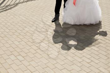 Beautiful shadow from the kissing newly-married couple on a stone blocks.