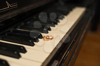 Wedding rings on piano keys.