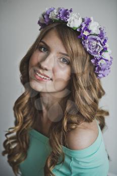 Girl in a wreath of lilac flowers.