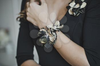 The corsage on the girls hand.