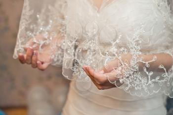Hands and dress of the bride 