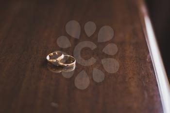 Two rings on a wooden table.