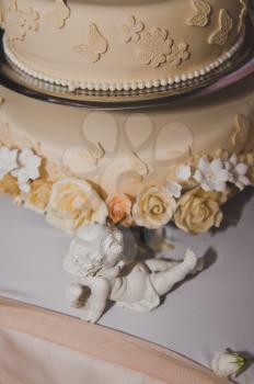 Delicate cake with flowers beige cream.
