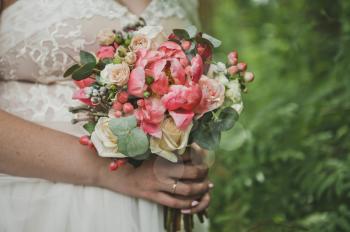 Bouquet in hands of bride.