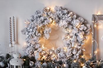 Decorated with white Christmas lights wreath on the wall.