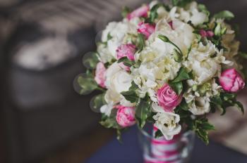 Beautiful bouquet of large white roses and greenery.
