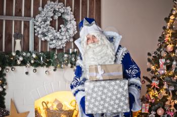 Santa Claus holding a gift Packed in large boxes.