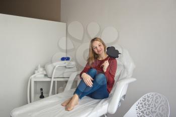 Girl sitting on a special medical chair.