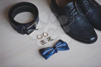 Shoes, belt, rings and butterfly.