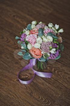 Wedding bouquet of flowers on the background of a lacquered table made of dark wood.
