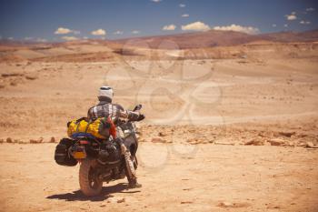 rider travels the Atacama Desert on a motorcycle. America