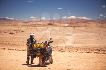 rider travels the Atacama Desert on a motorcycle. America