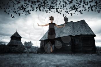 Witch floating in the air. picture in the style of a horror movie.