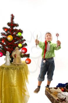 boy dresses up Christmas tree