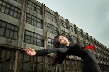 girl falls against the prospects of an old abandoned factory