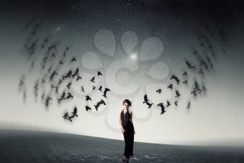 girl and a flock of crows. Elements of this image furnished by NASA