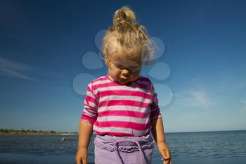 little girl weeping by the sea. summer vacation by the ocean