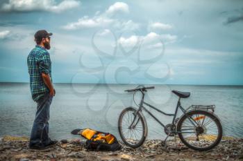 man on a bicycle near the sea. Travel and Recreation summer