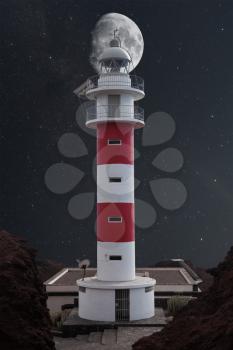 Lighthouse Punta de Teno is Tenerife on the Atlantic Ocean. night shining moon and stars
