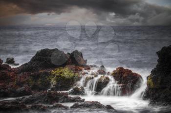 Storm in the ocean. Stones in the water are shot on a long exposure
