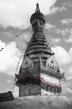 Swayambhunath Stupa stands on the hill in Kathmandu, Nepal. black and red and white photo