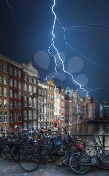 Strong thunder and powerful flashes of lightning. Amsterdam central historical part of the city, canals and houses
