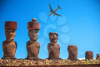 tourist plane flies over the statues of Easter Island