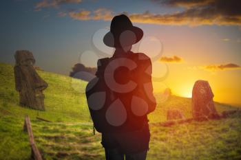 silhouette of a woman on a background of Easter Island statues. Chile.