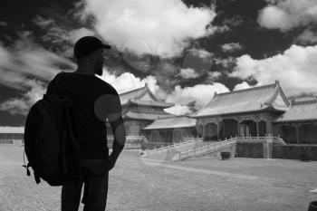 black and white photography. Silhouette of a man against the background of the Forbidden City of Beijing.