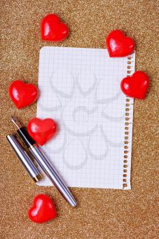 red hearts and note book on a table