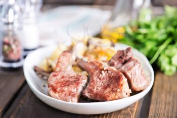 Rack of lamb fried with aromatic olive oil, herbs and spices
