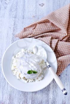 cottage with sour cream and on the plate
