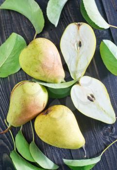 fresh pears and leaves on the wooden table
