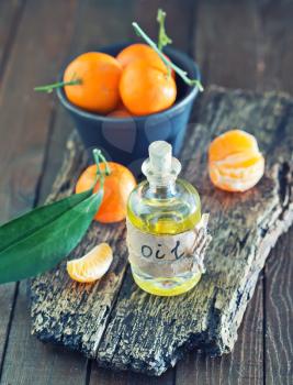 aroma oil and tangerines on the wooden board