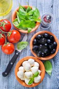 ingredients for caprese in bowl and on a table