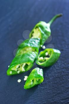 green chilli peppers on the black table