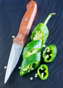 green chilli peppers on the black table