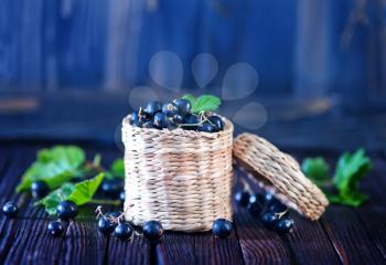 black currant in basket and on a table