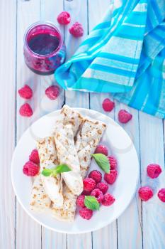 pancakes with fresh berries on the white plate