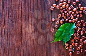 coffee beans and leaf on the wooden table