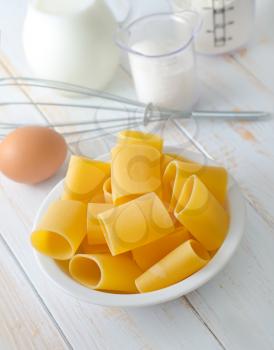 Raw yellow pasta and ingredients for pasta, sugar and flour