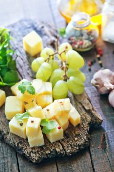 cheese and grape on the wooden board